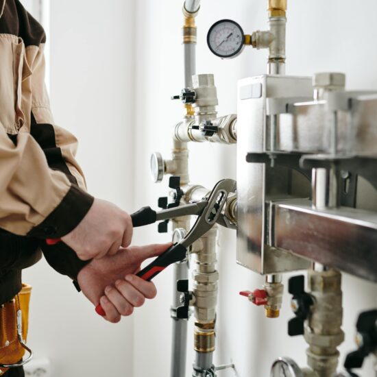 Professional plumber in Sunshine Coast repairing a water heater.