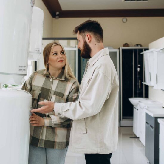 Young Couple Selecting new hot Water system with the assistance of the hot water specialists at Water Smart plumbing for hot water installation services